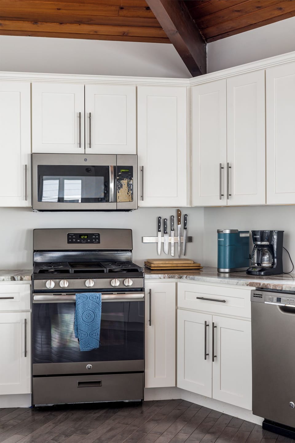 Well-equipped kitchen nook w/ stove, microwave & coffee maker for easy meals.