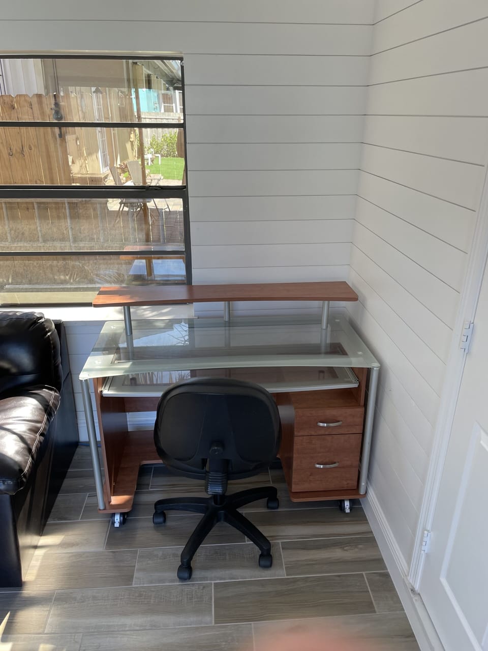 Desk and Desk Chair there is a door to close to separate from living space  