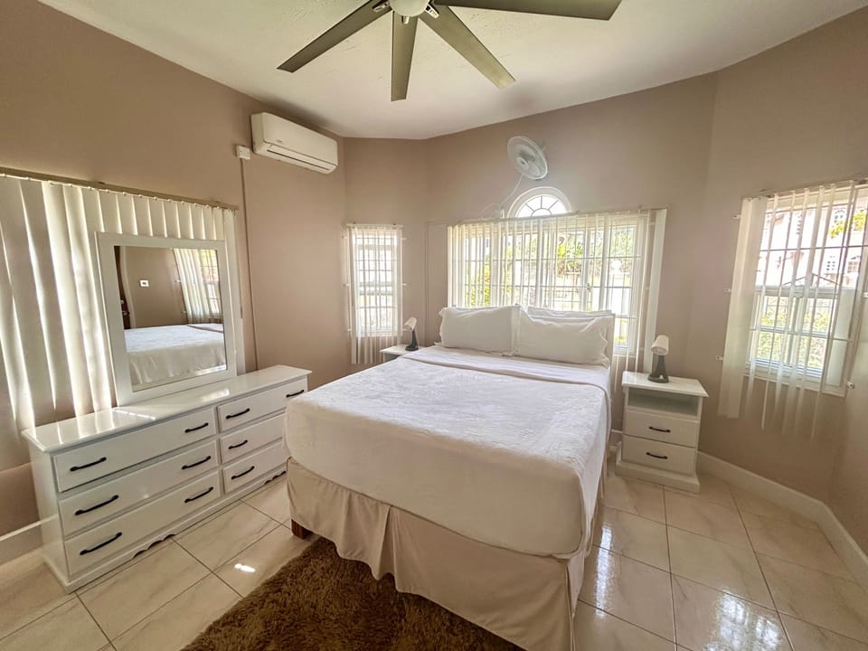 Bedroom 2 located downstairs comes equipped with a TV, a mini fridge as well as an ensuite bathroom. This room also allows you direct access to the outside of the property. 