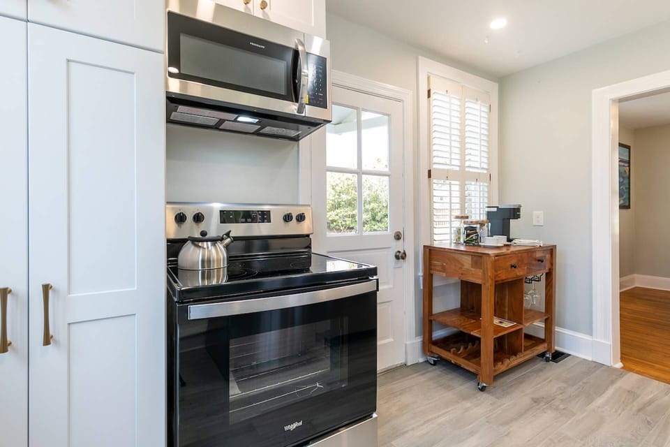 There is an electric stovetop, oven and microwave in the kitchen.