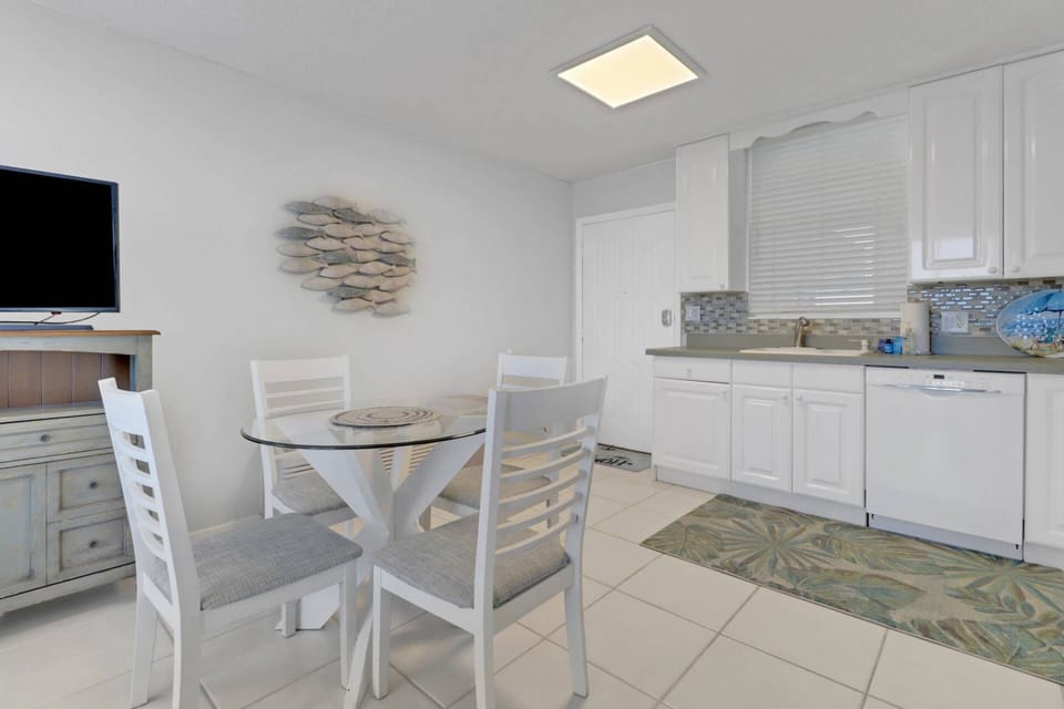Gather round for a meal or a game of cards at the dining table for 4 in the kitchen area.