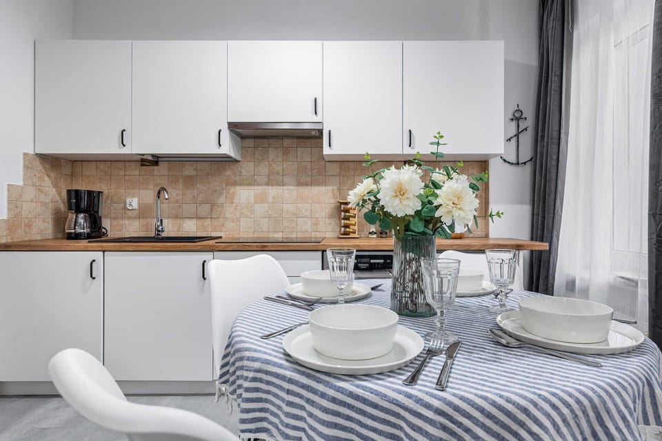 A small dining space with a round table, modern chairs, and a minimalist design.

