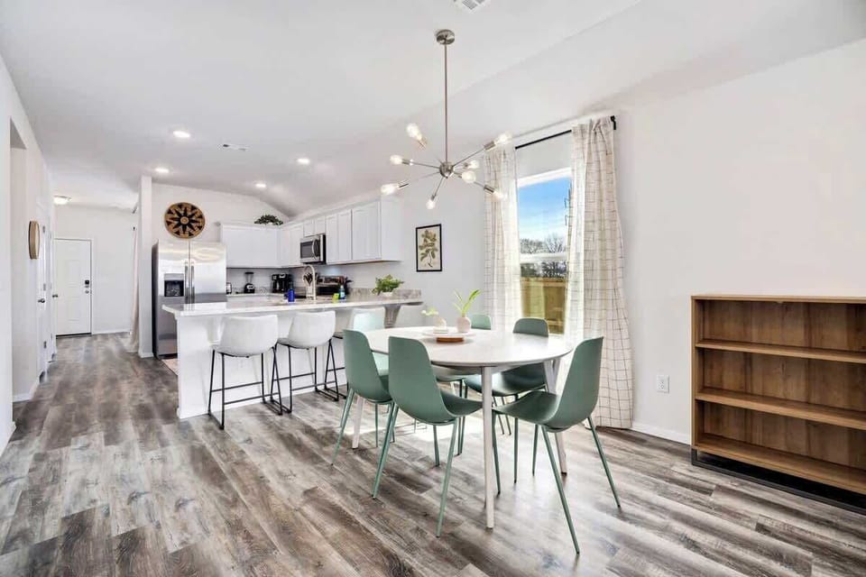 Next to the living room, you'll see our 6-top dining table and kitchen.