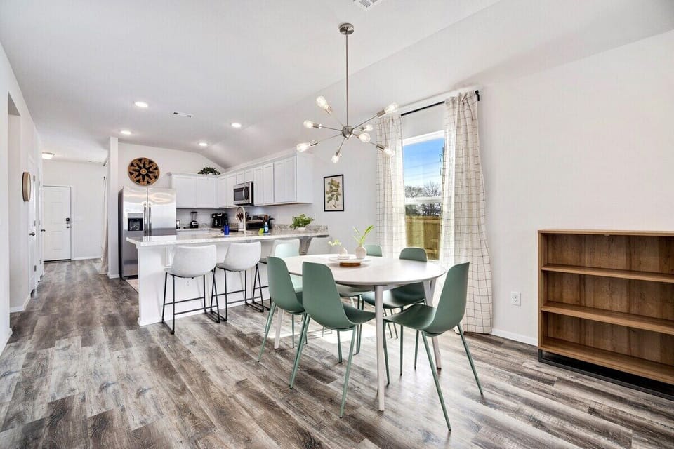 Next to the living room, you'll see our 6-top dining table and kitchen.