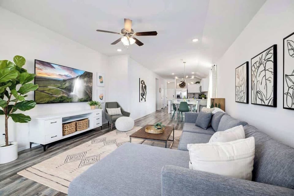 In our living room, curl up on our over-stuffed gray sectional to read a good book or stream a movie on our 75-inch TCL Roku TV.