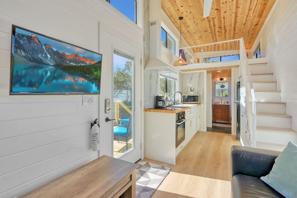 View of the entry door.  To the left at the end of the home can be seen the bathroom.