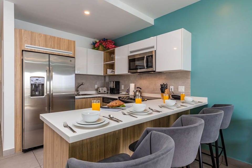 Keep your wardrobe fresh with in-unit laundry right at your fingertips. A stacked washer and dryer tucked neatly behind a cabinet means effortless convenience during your stay.