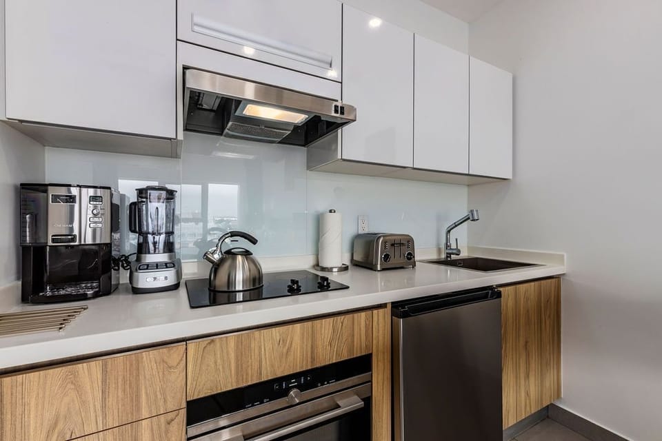 Your sleek modern kitchen awaits with stainless steel appliances, coffee maker, blender, toaster, and everything you need to prepare delicious home-cooked meals during your stay.