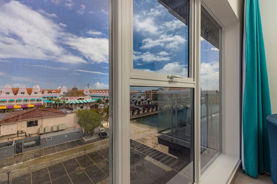The property is situated near a vibrant waterfront area with colorful nearby architecture, offering a distinctive tropical coastal setting that is easily accessible from your accommodations.
