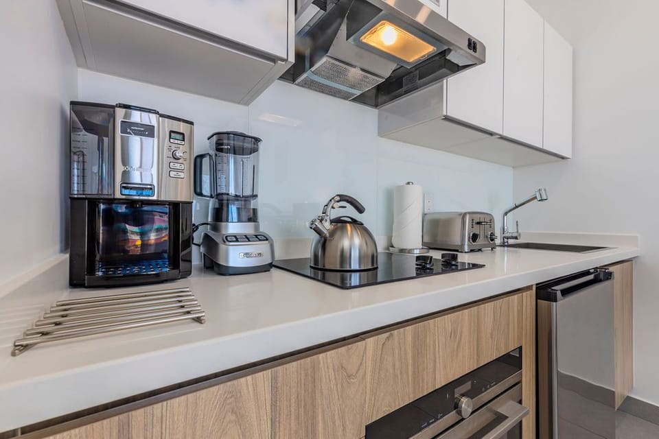 A fully equipped kitchen awaits your culinary adventures with modern appliances, sleek countertops, and everything you need to prepare meals during your stay.