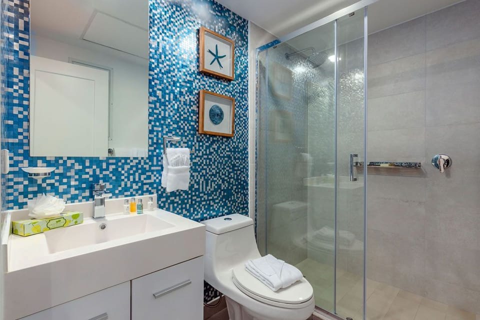 You'll love the sparkling shower and cheerful blue mosaic tiles that brighten your mornings. Nautical artwork and fluffy towels welcome you home after a busy day exploring.