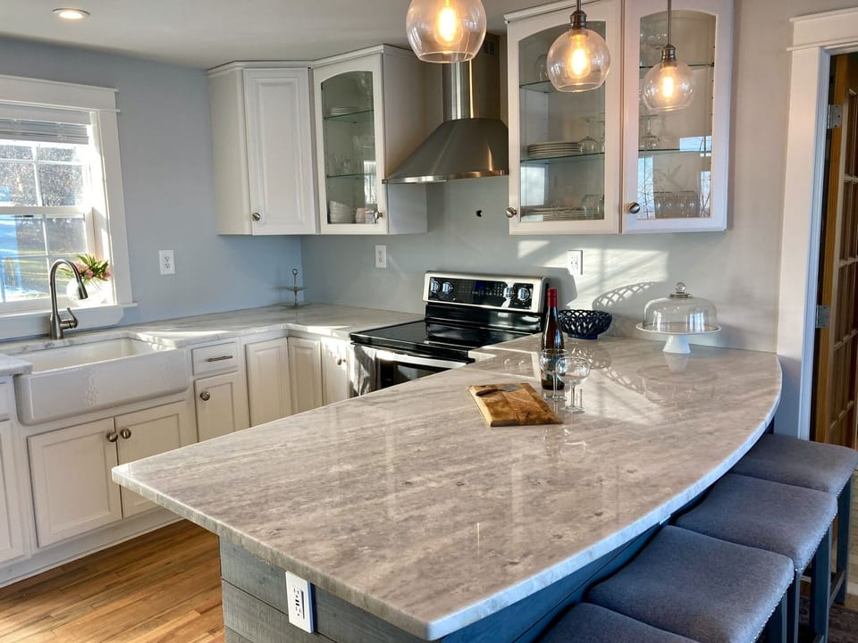Granite bar and farm front sink in kitchen