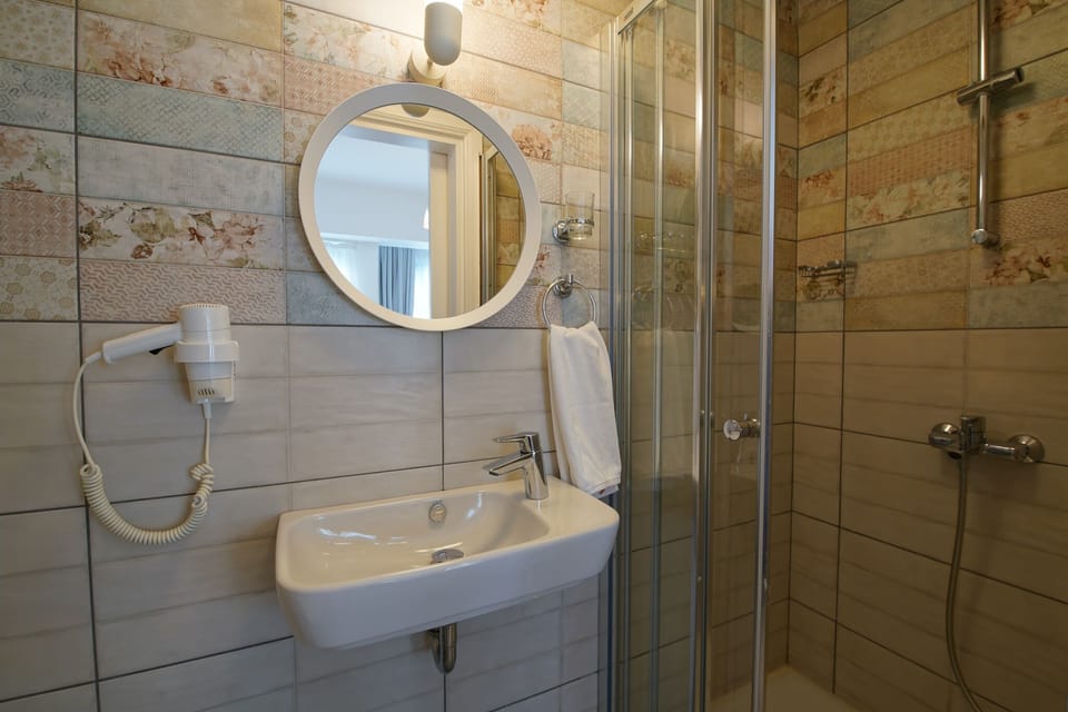 Deluxe Double Room, 1 Double Bed | Bathroom | Shower, hair dryer, towels, soap
