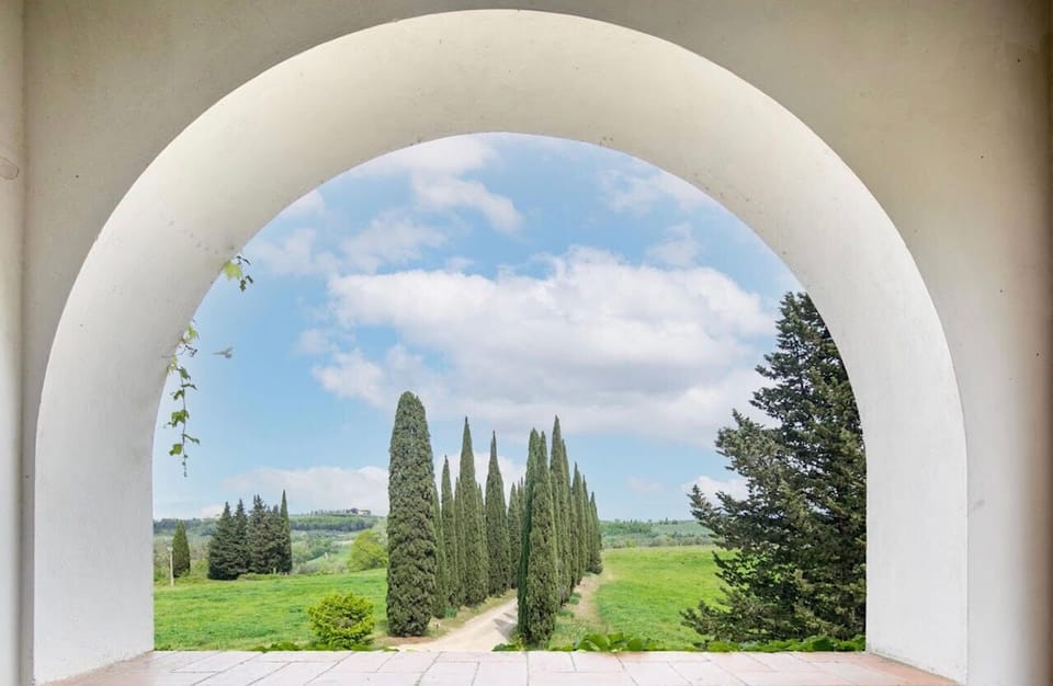 Experience classic Tuscan views framed by charming archways