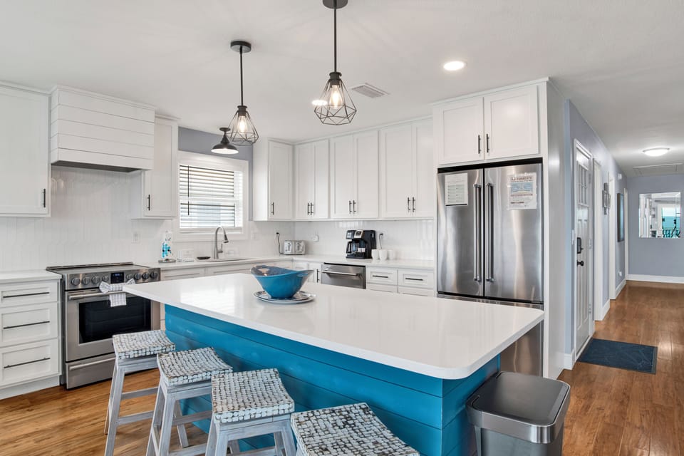 The kitchen features stone counters and stainless appliances