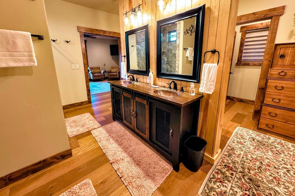 The master bath has a walk-in shower with his-and-hers shower heads. There is also a beautiful tub, three sinks, and plenty of space to store toiletries or other items.