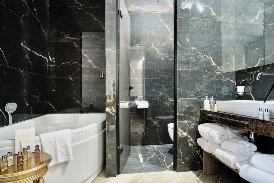 Blue Royal Suite with Indoor Massage Hot Tub | Bathroom | Jetted tub, rainfall showerhead, designer toiletries, hair dryer