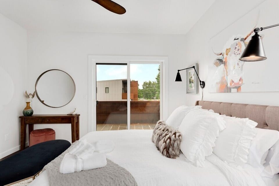 Our third bedroom, which is complete with a Queen bed, closet, vanity, vanity chair, and nearby bath.