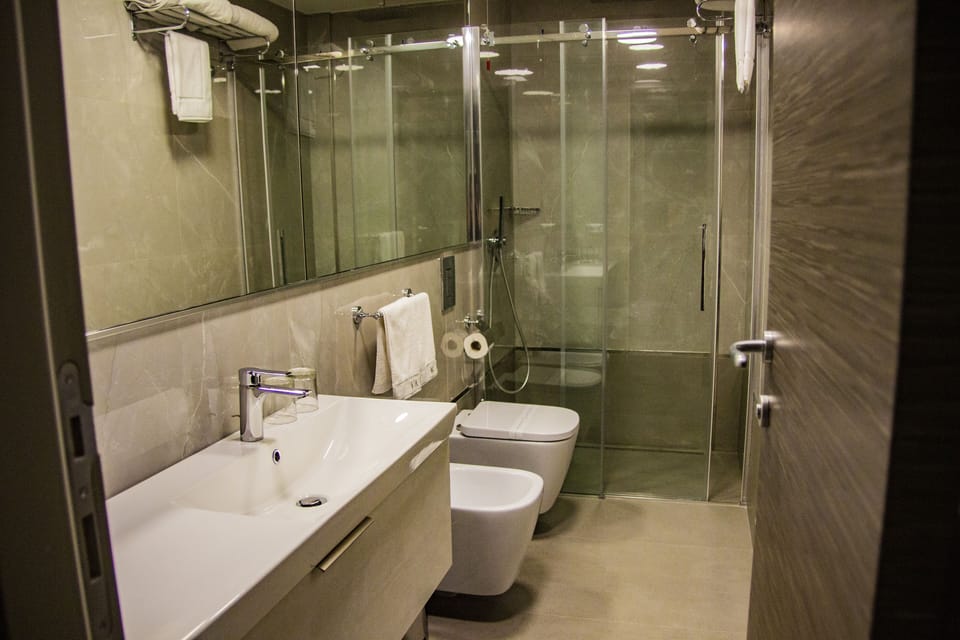 Shower, rainfall showerhead, designer toiletries, hair dryer