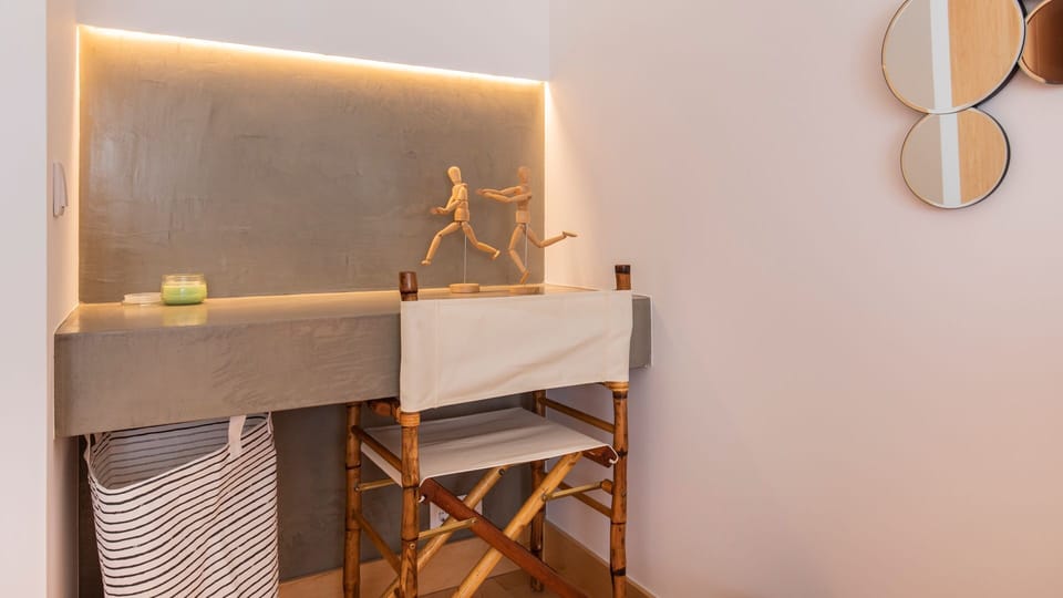 This dedicated workspace, illuminated by subtle backlighting, offers a focused area where creativity flows or important tasks can be completed with ease, blending functionality with a touch of modern design. #WorkspaceGoals #ProductiveVacation #ModernDesi