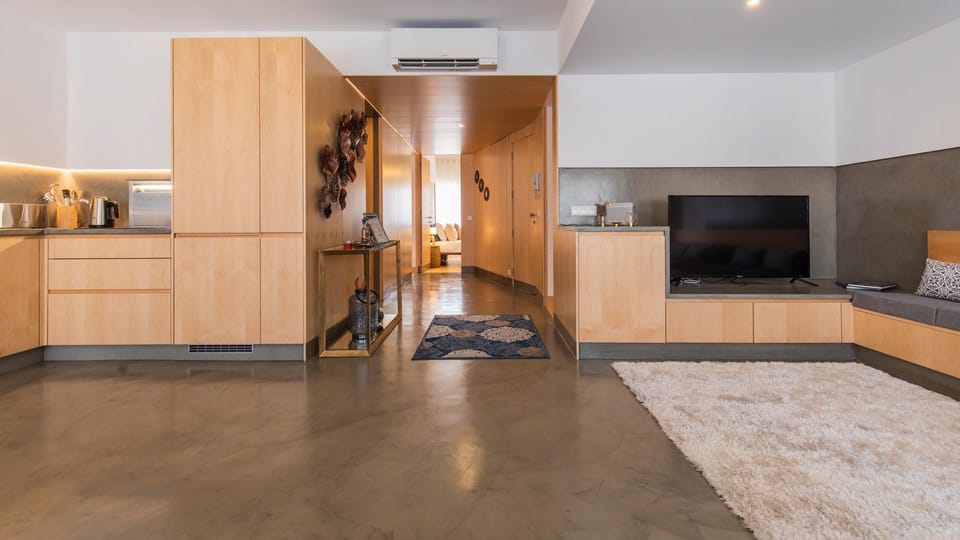 This expansive and open-plan living area provides ample space for families to spread out and relax, with a well-equipped kitchen seamlessly integrated for convenient meal preparation and entertaining. Enjoy the comfort of home with a flat-screen TV for en