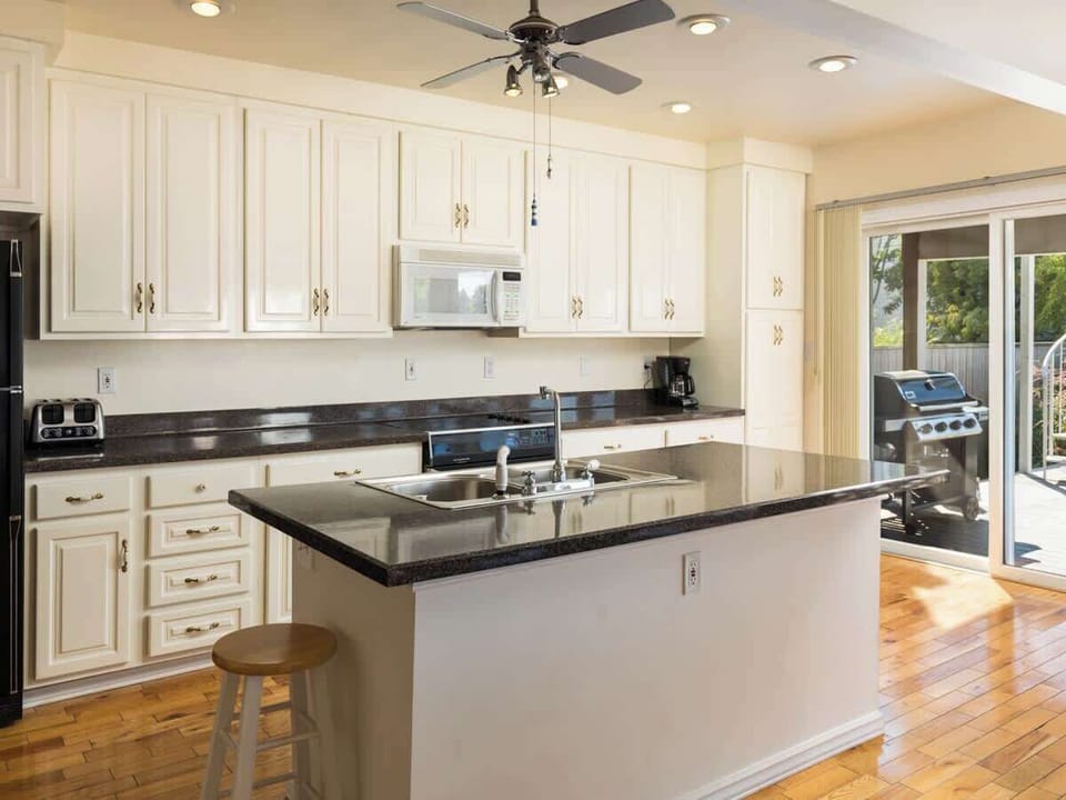 Whip up recipes in this inviting Kitchen with Bright Lighting, Ample Space, and Optional Gas Grill
