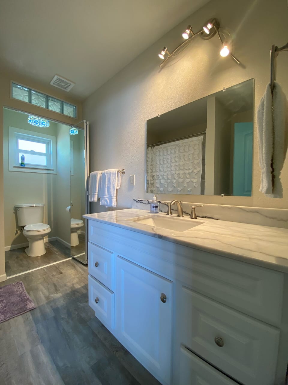 Main bath with marble top vanity and tub/shower