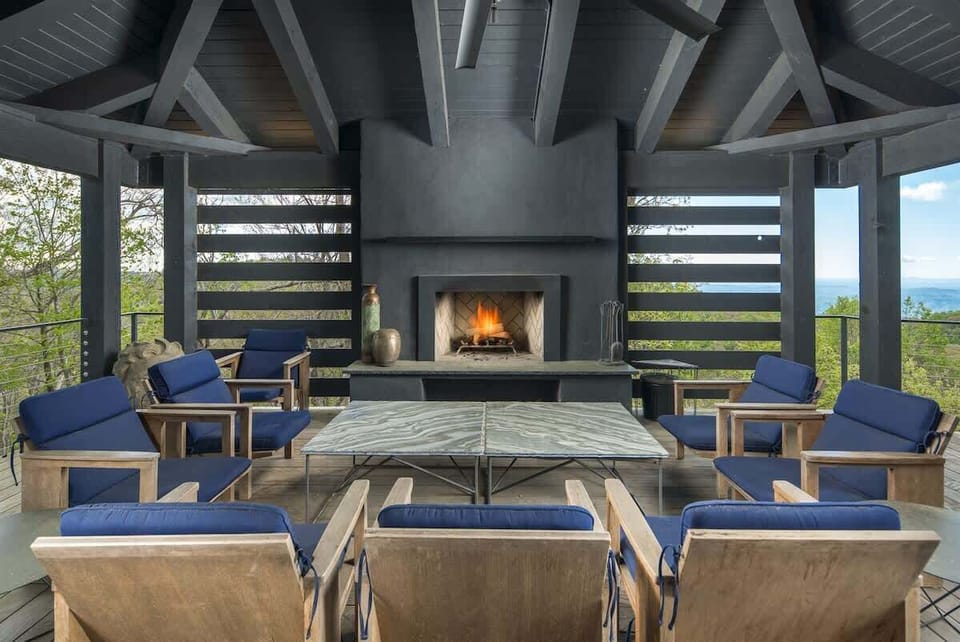 Covered outdoor space with fireplace for multi-season enjoyment.