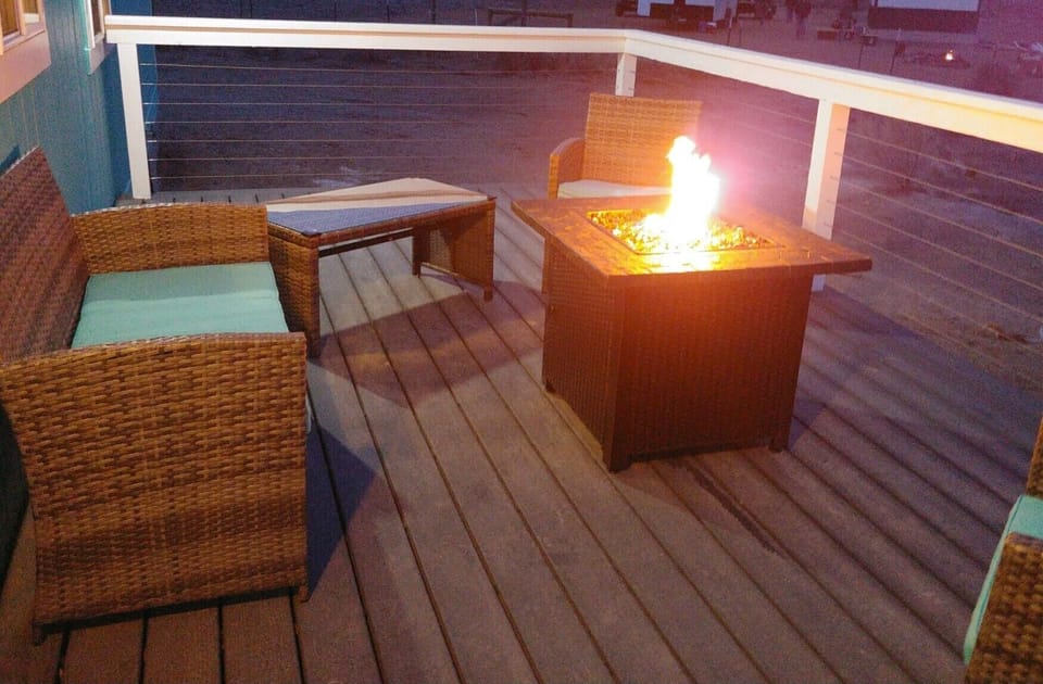 Back deck with patio furniture & propane fire pit.