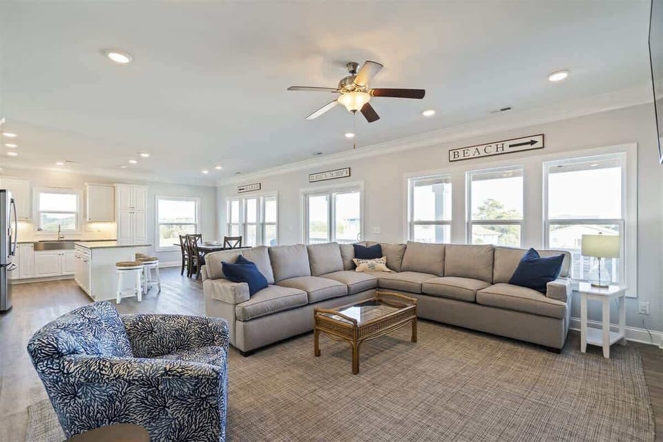 Living Room: Spacious gathering area with stylish decor and bright, beachy views!