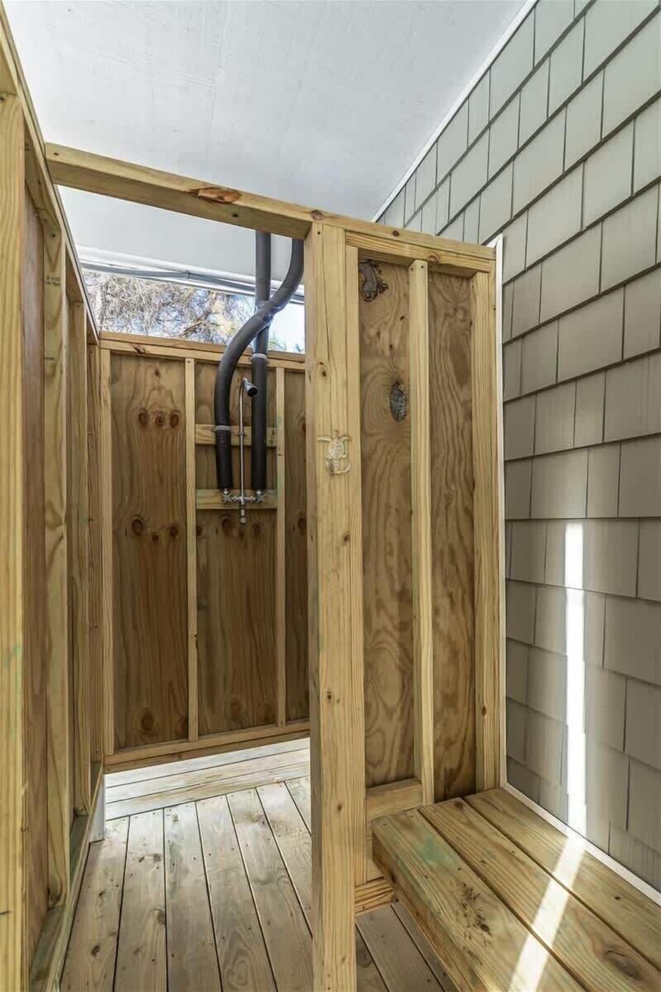 Outdoor Shower Retreat: Refresh after a beach day in this private, spacious wooden shower area!