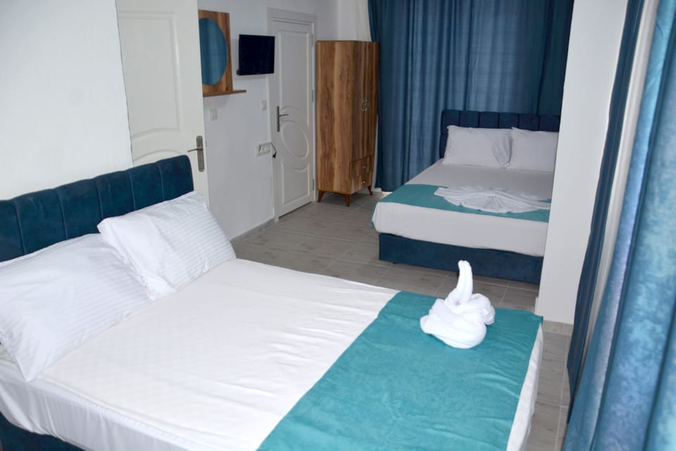 Family Quadruple Room | Living area | 32-inch LCD TV with satellite channels, TV