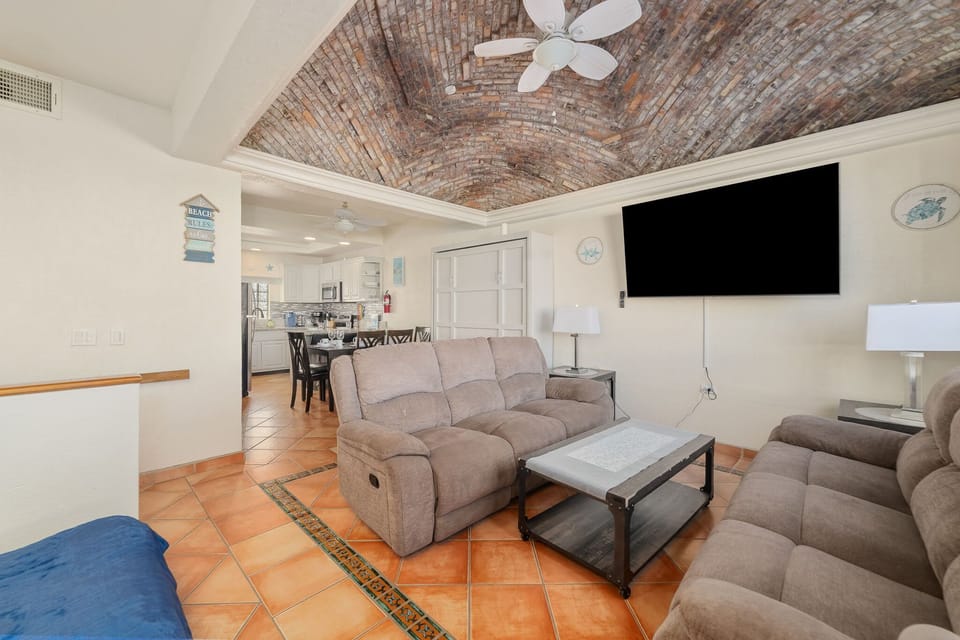 Relax upstairs with a large flat-screen TV, comfy recliners, and a beautiful domed brick ceiling centerpiece.