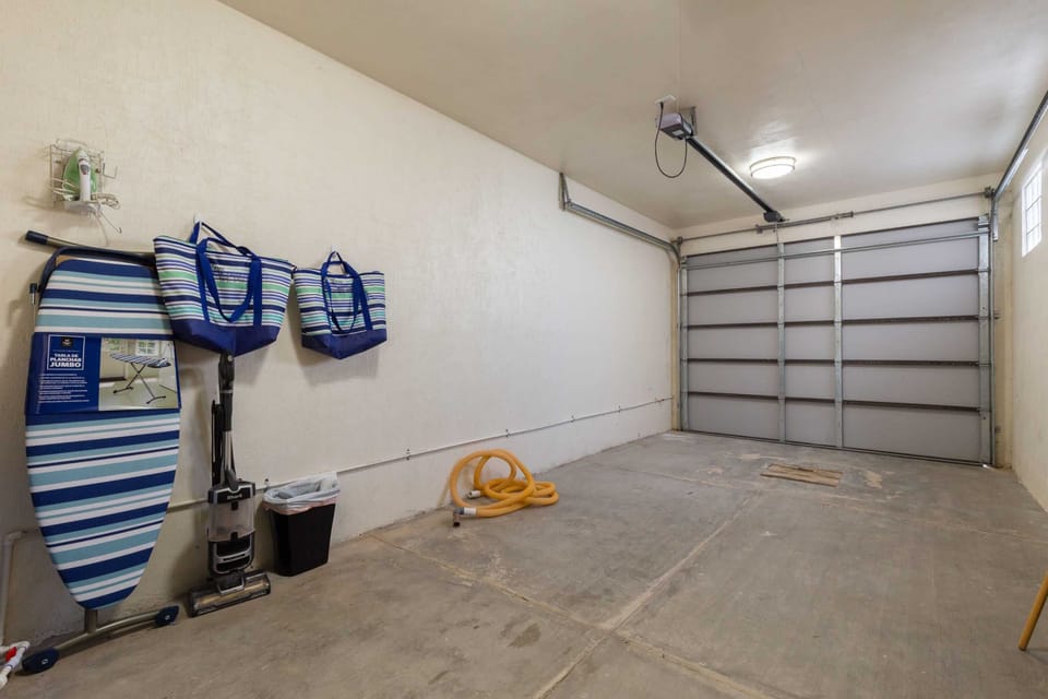 Spacious one-car garage with boogie boards, beach chairs, and plenty of room for bikes or additional items.