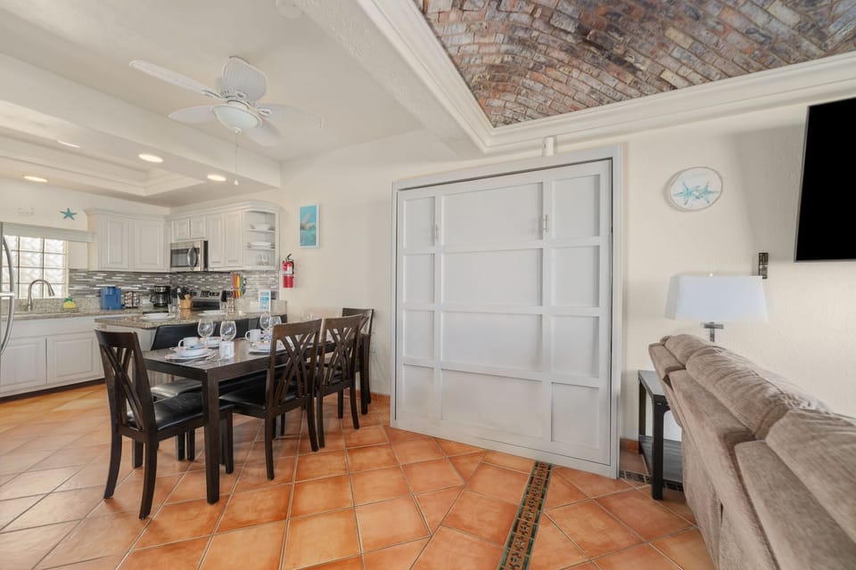 Gather for meals or board games at the full-size dining table with stylish place settings.