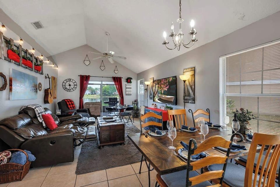 Cozy living room w/65" Roku TV. Dual electric reclining leather sofa & reclining chair, string lighting, farmhouse table w/6 chairs with access to the back patio. For larger groups a card table & 4 chairs can be added (in master bedroom closet).