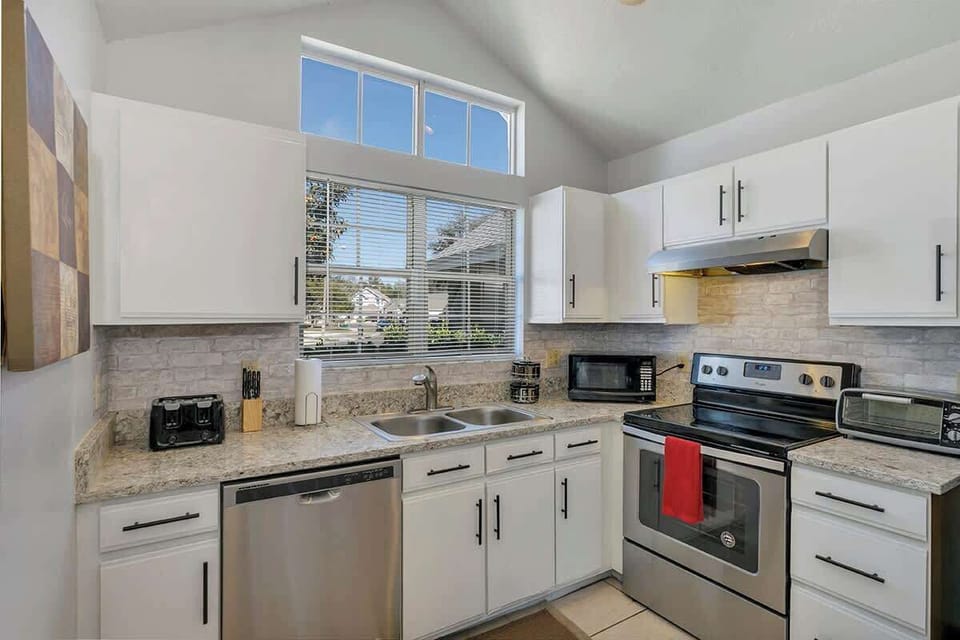 Spacious and inviting kitchen complete with Coffee Bar (k-cups, Keurig, coffee, coffee maker, creamer, sugar, sugar substitute, honey), pots & pans, silverware and everything you should need to make this your home away from home!