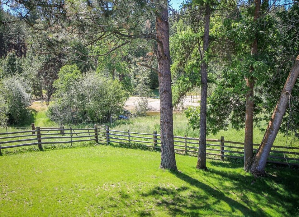 Large manicured lawn with expansive grazing pastures beyond