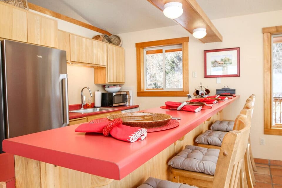 Kitchen with open floor plan to dining and living room.  Wrap-around windows provide ample natural light and breathtaking views from the entire main level!  Casual dining at the large breakfast bar.