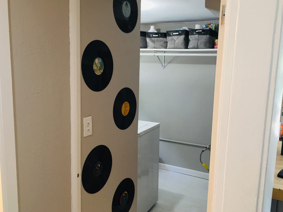Laundry room with lots of space to hand dresses and suits.