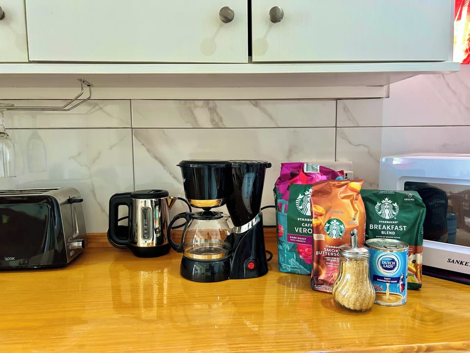 Features a microwave, toaster, hot water kettle and coffee maker.