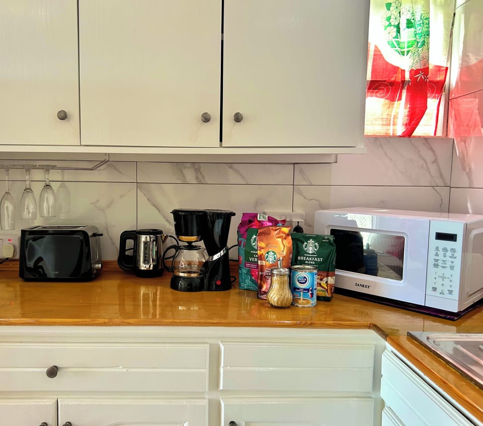 Features a microwave, toaster, hot water kettle and coffee maker.