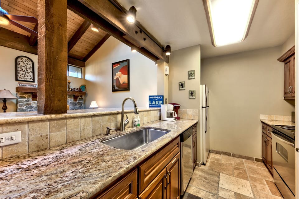Your fully equipped kitchen features granite counters, exposed beams, and everything needed to create memorable meals during your stay.
