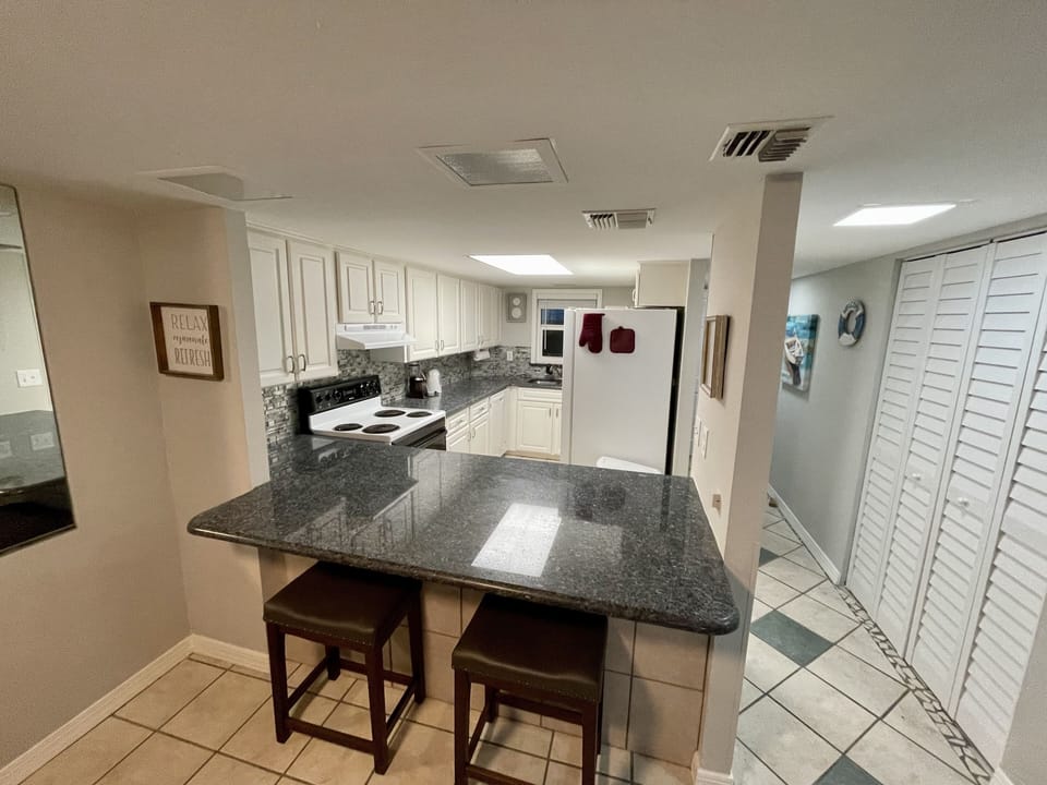 Expansive bar with a view to the well appointed kitchen