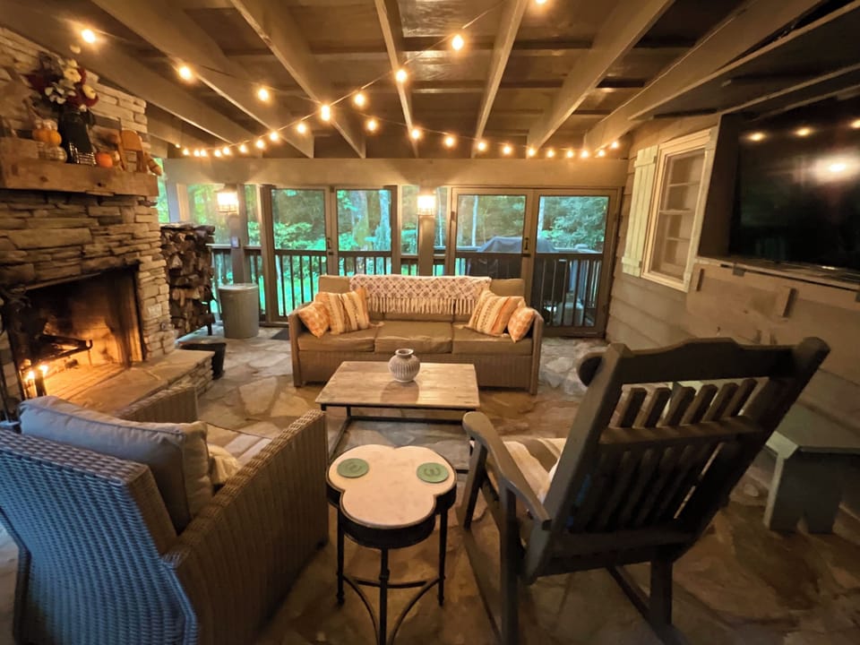 Screened porch with wood burning fireplace , large tv and grill