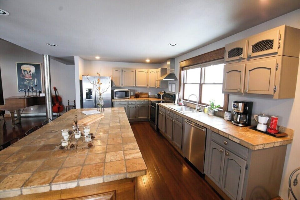 Chefs kitchen with ample counter space, coffee & tea bar, microwave, oven, stove, fridge, dishwasher and open floor plan perfect for entertaining