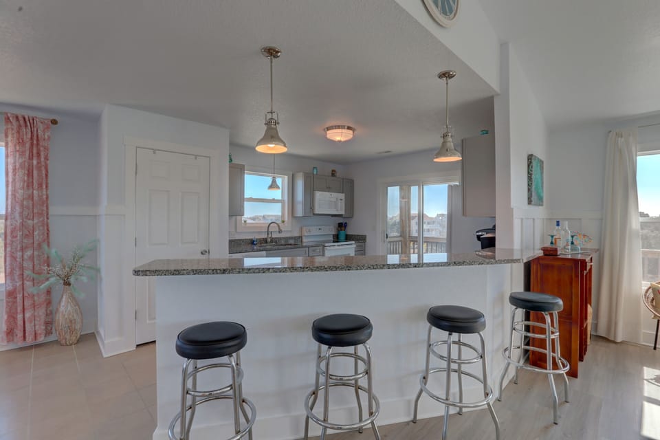 Island offers 4 more seats to chat while dinner is prepped