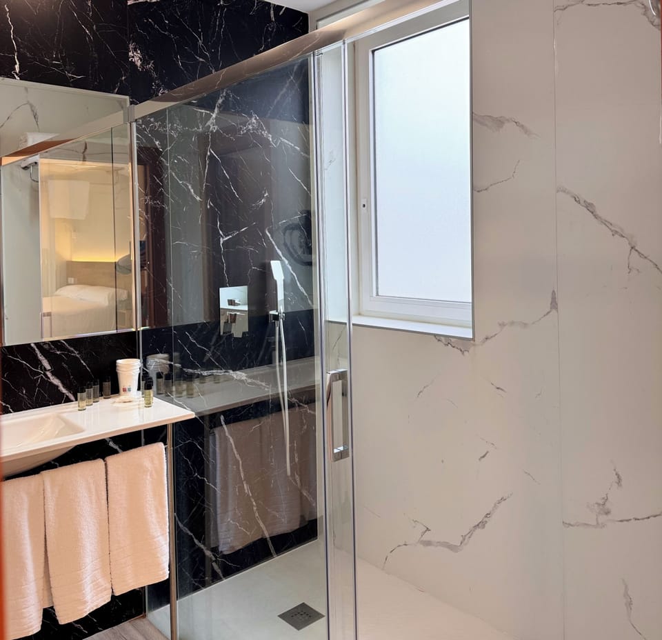 Classic Quadruple Room | Bathroom | Shower, hair dryer, towels, soap