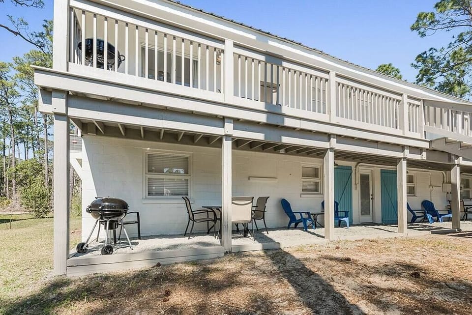 Enjoy a covered patio with a BBQ grill, perfect for cooking and dining outdoors.