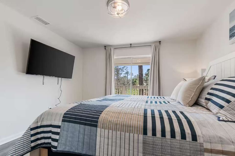 Bedroom equipped with a TV for relaxing and unwinding at night.